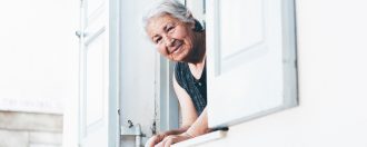 Elderly lady looking out of a window