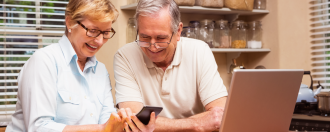 Elderly couple on a laptop together