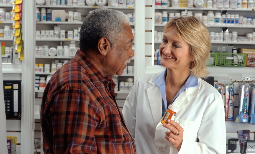 Pharmacist helping man with his medication