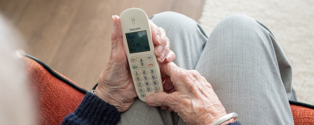 Elderly Person Holding Telephone