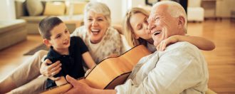 Elderly grandparents playing instruments with their grandchildren