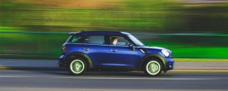 Small Car Driving on Road